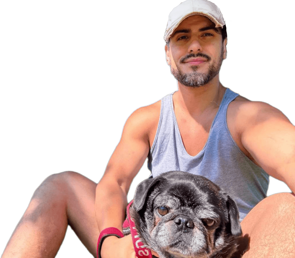 Tyler sitting in the park with one of his pugs